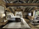kings-avenue-luxury-chalet-courchevel-001-master-bedroom-with-tv-and-views