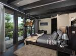 kings-avenue-luxury-chalet-courchevel-003-bedroom-with-tv-and-mountain-views