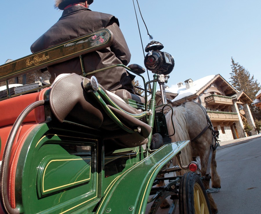 kings-avenue-luxury-chalet-courchevel-005-transport-with-horse-and-carriage-in-snow-with-blue-sky