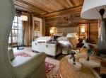 kings-avenue-luxury-chalet-courchevel-005-wooden-bedroom-with-views