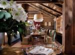 kings-avenue-luxury-chalet-courchevel-005-wooden-living-room-with-dining-table