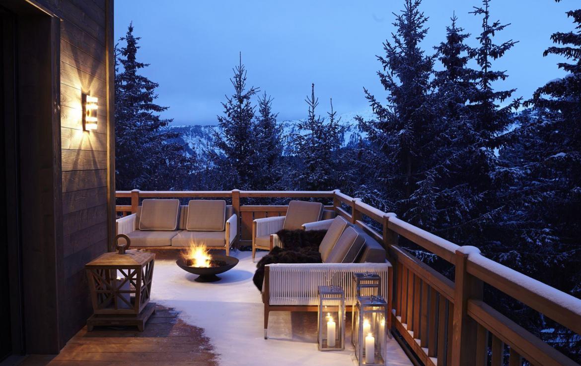 kings-avenue-luxury-chalet-courchevel-008-balcony-with-fireplace-and-mountain-views