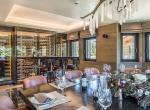kings-avenue-luxury-chalet-courchevel-008-dining-area-with-wine-cellar