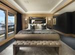 kings-avenue-luxury-chalet-courchevel-009-master-bedroom-with-balcony-and-mountain-views
