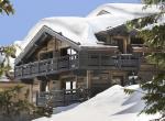 kings-avenue-luxury-chalet-courchevel-009-side-view-exterior-blue-sky-snow