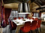 kings-avenue-luxury-chalet-courchevel-010-dining-room-with-dining-table-and-balcony